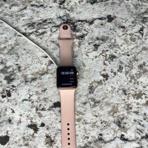3 series Apple smart watch. Color is rose gold.